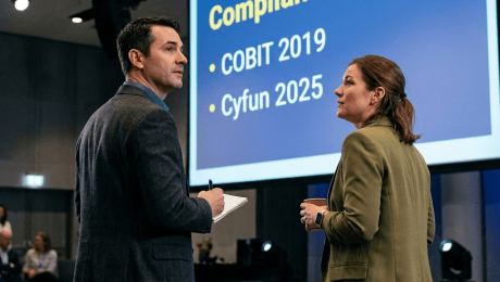 Two professionals discuss a presentation featuring a Global Data Flow Analysis Q3 2024 Update dashboard.